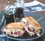 Two halves of a reuben sandwich stacked on a plate