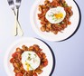 Two plates of mushroom potato hash with poached eggs on top