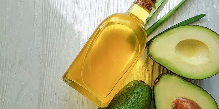 Avocado oil on white wood
