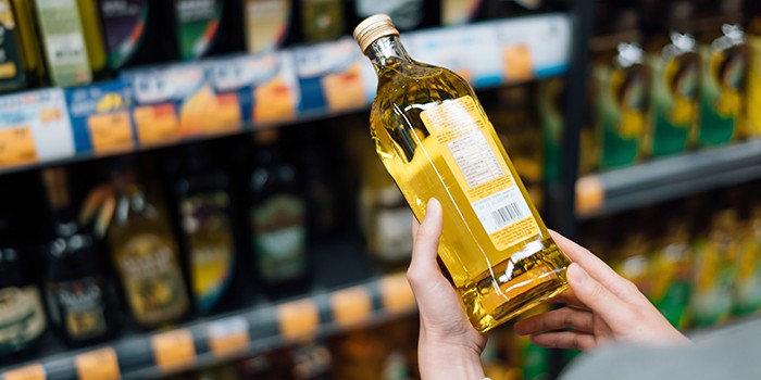 Checking a bottle of olive oil