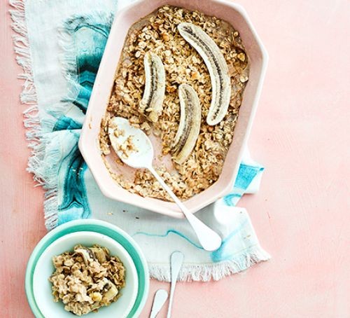 A baking dish of baked oats topped with bananas