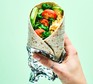 Breakfast burrito served in a foil sleeve