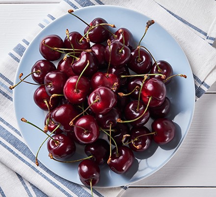 Cherries on a blue plate