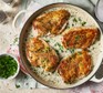 Chicken in white wine sauce in a baking dish