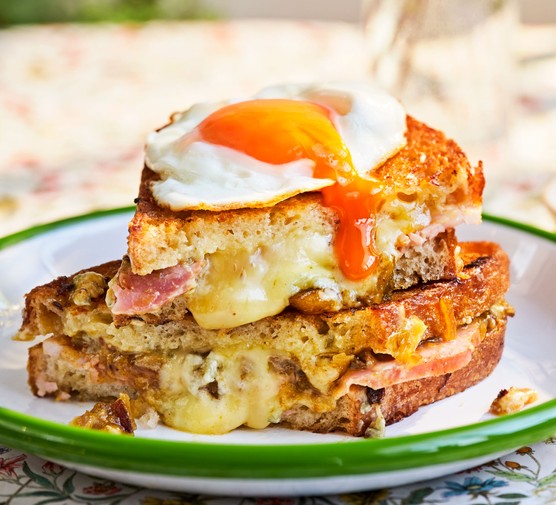 Blue cheese and ham toastie Blue cheese and ham toastie topped with a fried egg served on a plate