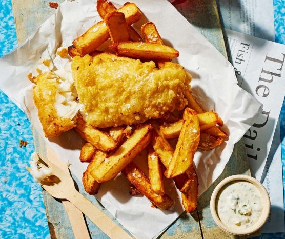 A portion of fish and chips in newspaper