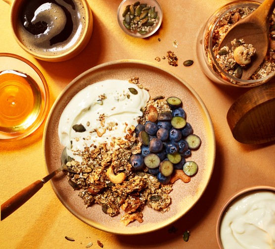 Soya yogurt sits in a bowl with granola