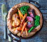 Giant Yorkshire pudding Sunday lunch with cutlery served alongside