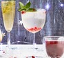 Gin-free G&T served in a large glass and decorated with pomegranate seeds