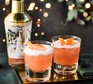 Grapefruit sours in glasses with cocktail shaker