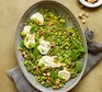 Lemony broad beans with goat's cheese, peas & mint in a large dish