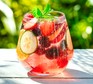 Summer mocktail in glass with fruit and ice