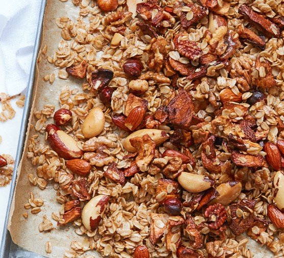 A tray of freshly baked granola made with nuts and seeds
