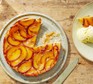 Peach tarte tatin with a slice cut away