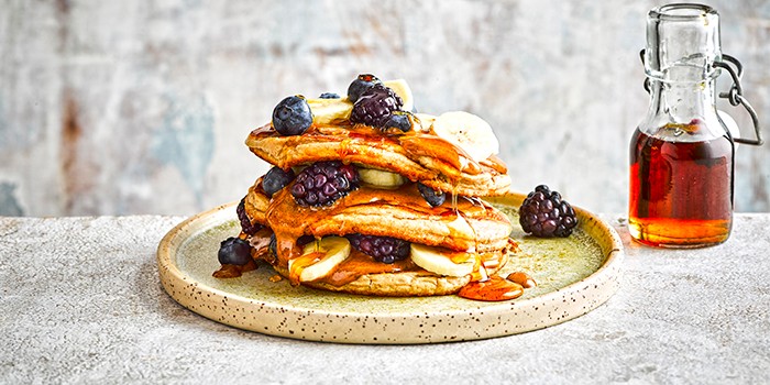 Easy protein pancakes Stack of protein pancakes with nut butter and berries