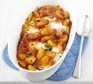 Gnocchi & tomato bake in a serving dish with spoon