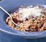 Mushroom risotto sprinkled with parmesan in a bowl