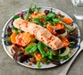Salad topped with a salmon fillet
