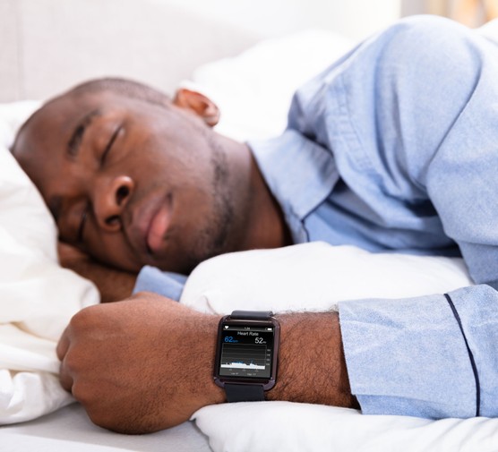 Man wearing a sleep tracker while sleeping
