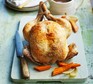 Chicken on board with vegetables and knife
