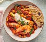 Smoky prawn, fish & chickpea one-pot served with bread
