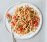 A plate serving healthy bolognese with a fork