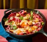 Spicy Bloody Mary eggs with crunchy croutons in an iron pan