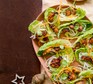 Several sticky pork & rice noodle lettuce wraps served on a plate