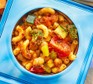 A small tupperware pot filled with storecupboard saucy pasta & chickpeas