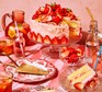 Strawberry lemonade cake on a cake stand with a slice cut out
