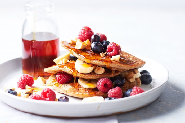Stack of pancakes with berries and banana