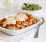 Vegetarian enchiladas in a baking dish covered with cheese